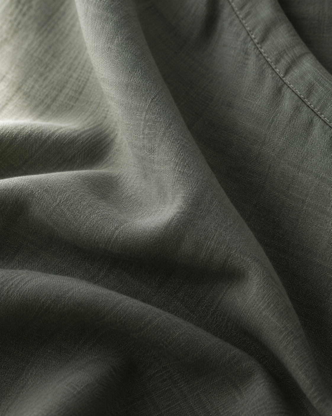 Close-up of softly folded moss hemp-blend scrub fabric